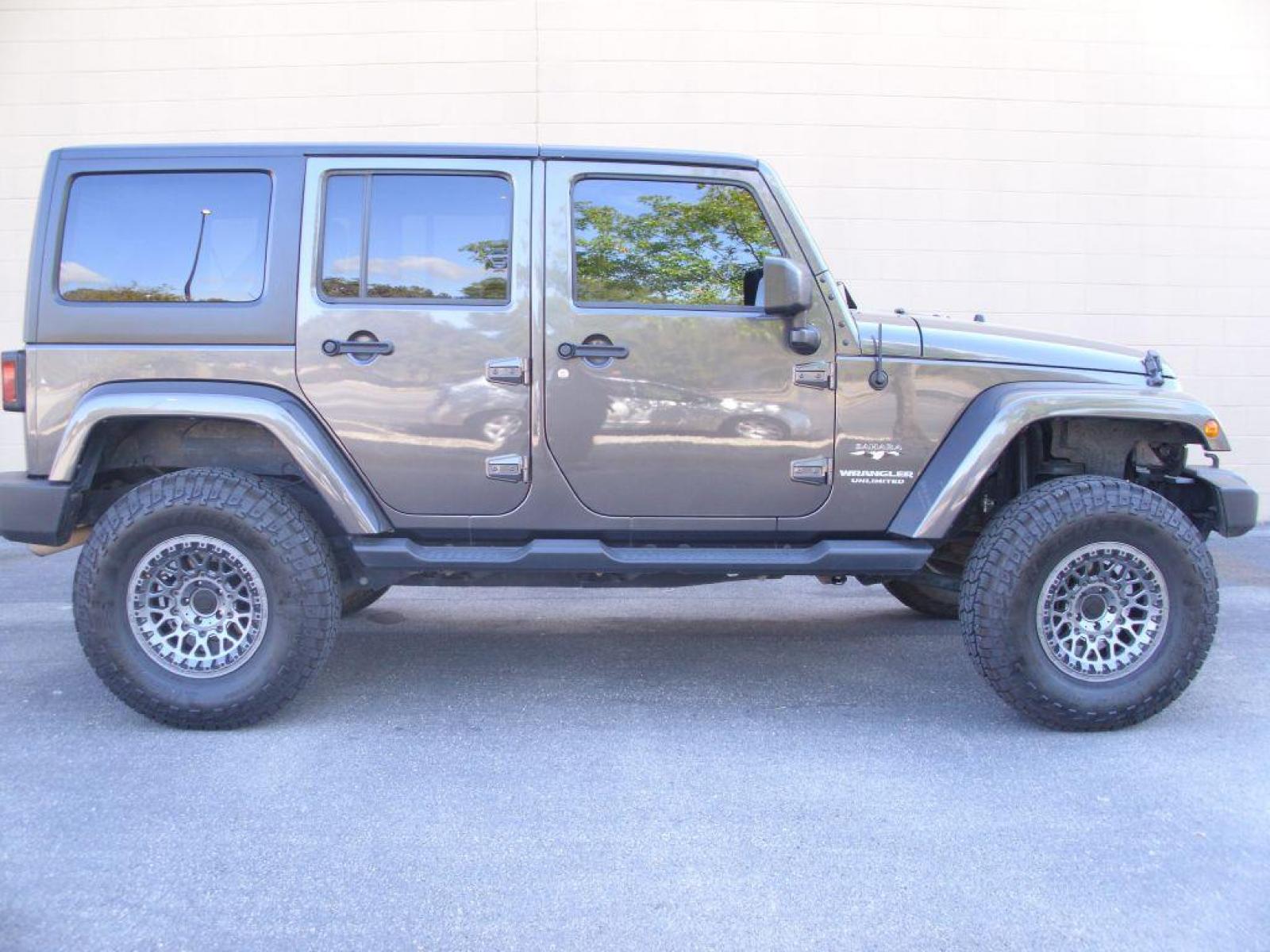 2016 GRAY JEEP WRANGLER UNLIMI SAHARA (1C4BJWEG8GL) with an 3.6L engine, Automatic transmission, located at 12019 San Pedro Avenue, San Antonio, TX, 78216, (210) 494-5895, 29.551861, -98.487602 - New Lift Metal Cloak; New Wheels; 35 inch Off-Road Hercules; Bluetooth Technology; Cruise Control; Fron Seat Heaters; Hard Top; Leather Seats; Navigation System; Remote Start; Running Boards; Satellite Radio; Tow Hitch; Air Conditioning; Power Windows; Power Locks; Power Steering; Tilt Wheel; AM/FM - Photo #0