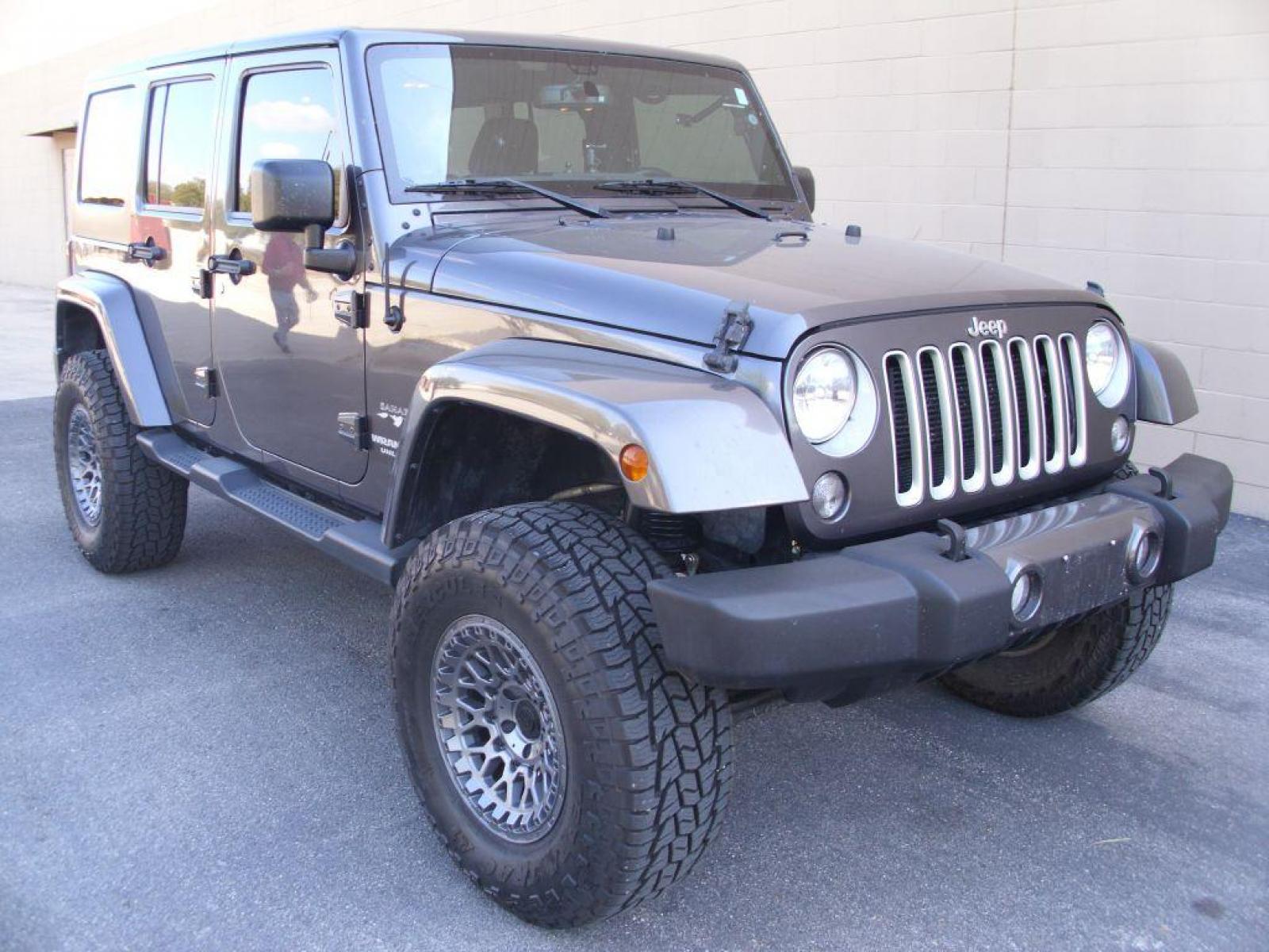 2016 GRAY JEEP WRANGLER UNLIMI SAHARA (1C4BJWEG8GL) with an 3.6L engine, Automatic transmission, located at 12019 San Pedro Avenue, San Antonio, TX, 78216, (210) 494-5895, 29.551861, -98.487602 - New Lift Metal Cloak; New Wheels; 35 inch Off-Road Hercules; Bluetooth Technology; Cruise Control; Fron Seat Heaters; Hard Top; Leather Seats; Navigation System; Remote Start; Running Boards; Satellite Radio; Tow Hitch; Air Conditioning; Power Windows; Power Locks; Power Steering; Tilt Wheel; AM/FM - Photo #3